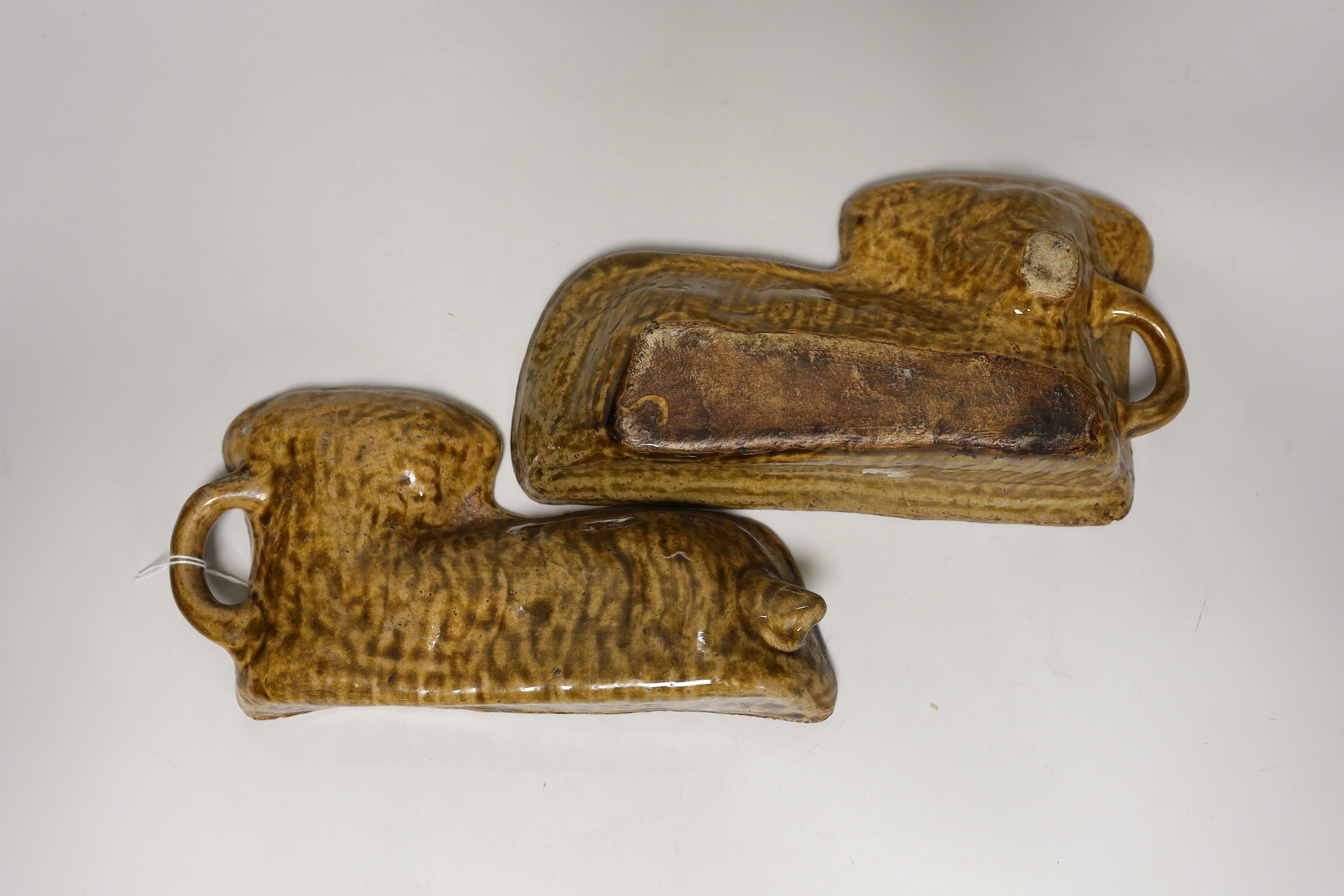 A 19th century lead glazed pottery 'lamb' baking mould, in two halves, 29cm wide